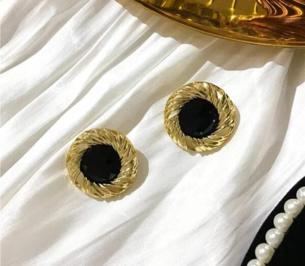 Black and gold round shaped stud earrings